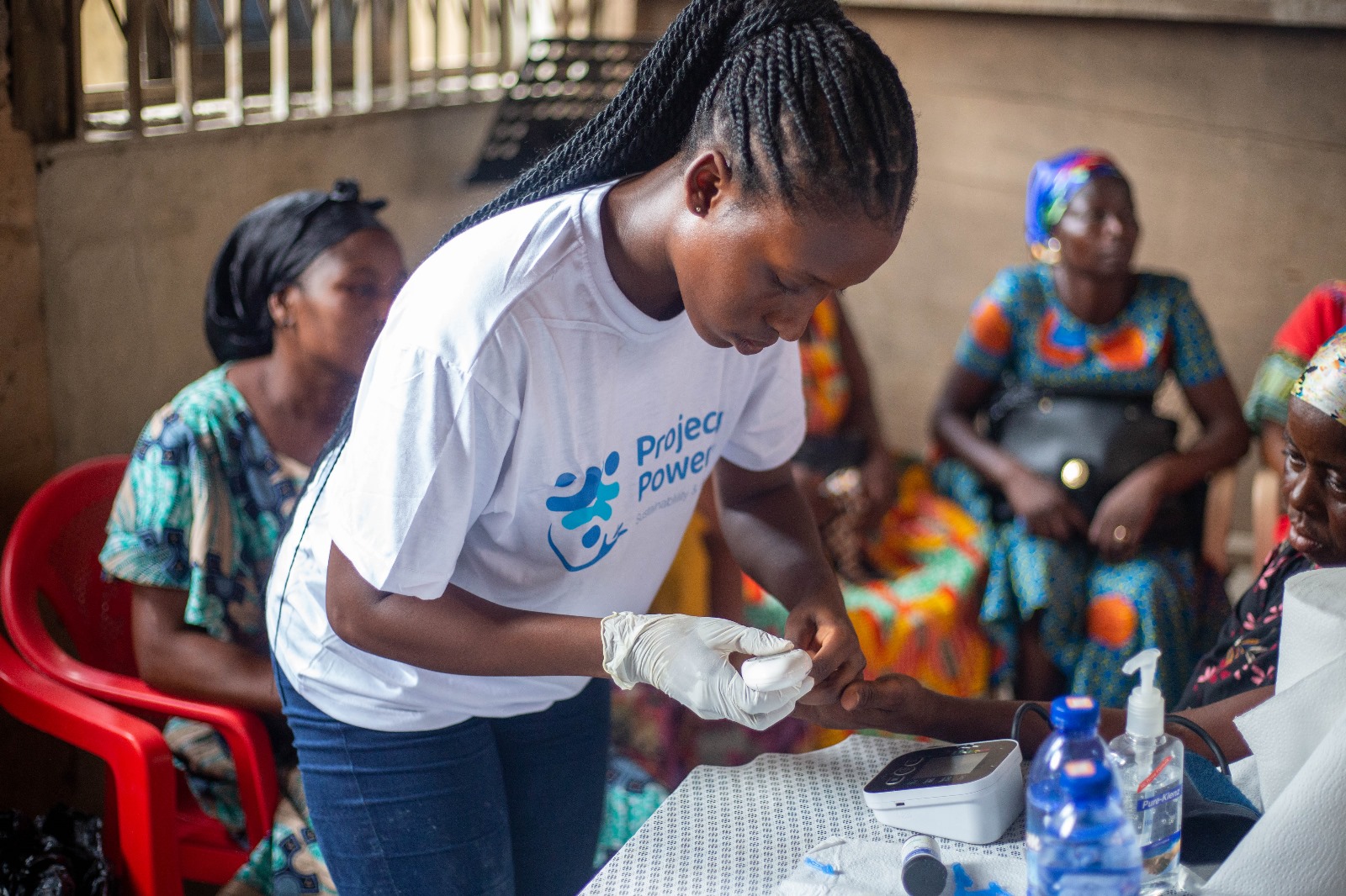 Health worker conducting blood glucose test